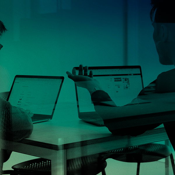 Two people discuss business telecoms strategy in an office